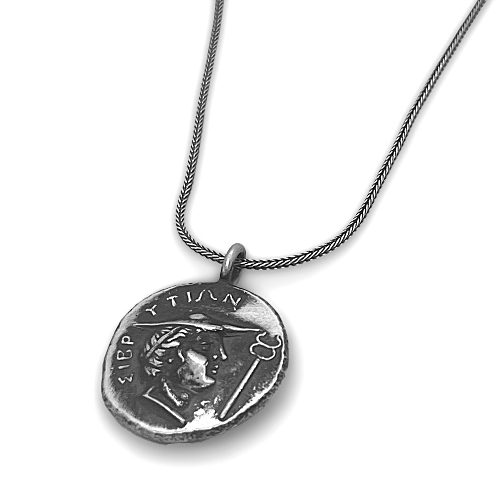 Reverse side of Silver Stater necklace featuring youthful head of Hermes with ΣΥΒΡΥΤΙΩΝ inscription from ancient Crete